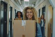 © Vorda Berge - Smiling female college students carry boxes in dormitory hallway on moving day
