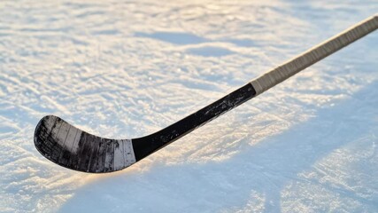 Poster - A hockey stick lies in the snow, a winter scene