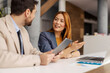 © Dusan Petkovic - Smiling businesswoman sitting at boardroom and explaining business strategy to her coworker on sprint meeting.