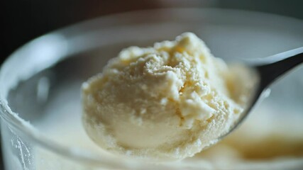 Poster - A spoon holds a scoop of creamy ice cream, ready for eating
