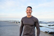 © MollerFinest/peopleimages.com - Mature man, runner and smile on promenade by ocean, break or pride with portrait for workout in morning. Person, training and fitness by sea with confidence, happy or outdoor for exercise in Spain
