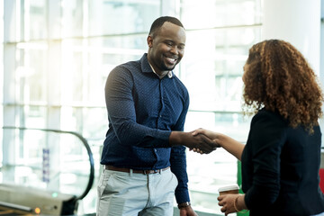 Aufkleber - Handshake, smile and welcome with business people in airport lobby for friendly greeting or meeting. B2B, escalator or travel with employee man and woman shaking hands for international partnership
