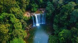 A beautiful view of Haew Suwat Waterfall from above, with a pristine forest and the stream flowing calmly below.