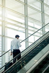 Poster - escalator, airport and businessman with phone and suitcase for travel, commute and arrival in lobby 