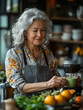 © Sukifli Dakheng - Senior woman preparing healthy smoothie in cozy kitchen filled with fresh ingredients