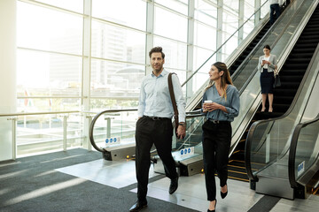 Poster - Office, walking and business people in lobby for meeting, discussion and arrival at networking event. Professional, corporate and man and woman at conference, convention and seminar in building