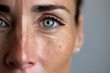 © Emanuel - Portrait of a woman with one side showing natural beauty and the other post-cosmetic transformation, soft lighting and textured skin contrast