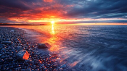 Poster - Stunning sunset over ocean water with dramatic colors and clouds creating a beautiful natural scene of serenity and tranquility