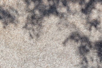 Aufkleber - Leaves shadows. Leaves bokeh nature sunny summer cozy background with sunlight. Leaves and trees shadows on gray concrete stone surface. Gray summer background copy space. Concrete wall with sunlight