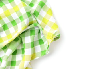Leinwandbilder - Folded, vibrant green and yellow checkered cloth napkin  Close-up, isolated on white background  Fabric is draped and wrinkled
