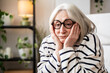 © Westend61 - Thoughtful woman with white sitting with head in hands looking despaired