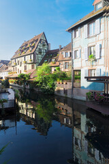 Wall Mural - half timbered crooked houses of colmar with reflections in water, alsace, france