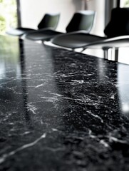 Leinwandbilder - Elegant black marble conference table with modern chairs reflecting natural light in minimalist setting