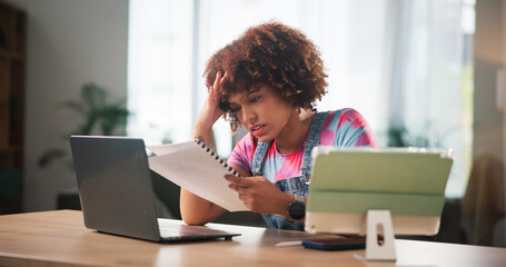 Fototapete - Frustrated woman, laptop and documents with stress for debt review, missed payment or bills at home. Female person, bankruptcy or freelancer with paperwork for financial crisis or expenses at house