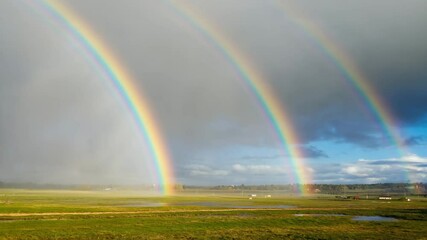 Poster - Rainbow arching over open fields after a heavy rainstorm..

