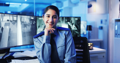 Poster - CCTV, face and security with woman in office at night for government, law enforcement or monitoring. Computer screen, smile and surveillance with police officer at desk in control room for dispatch