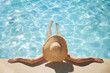 © Rido - Top view of woman relaxing at swimming pool
