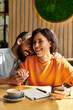 © LIGHTFIELD STUDIOS - Joyful moments shared by a couple in a cozy cafe atmosphere