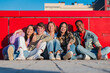 © Jose Calsina - A cheerful gathering of five friends expressing joy and camaraderie while sitting close together, showcasing their strong bond and unity through laughter and smiles in a delightful atmosphere.