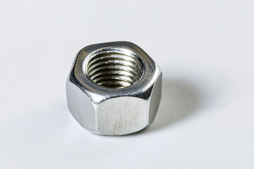 Aufkleber - Metal nut resting on a clean white background in daylight Generative AI