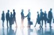 © AMINE - Silhouetted business people shake hands in a busy office setting.