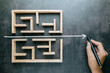 © patpitchaya - A hand that draws a straight line through a maze game with the shortest possible line, shorten the process, and simplify concept