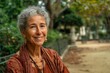 © Marcos Kulenkampff - A warm portrait of a smiling older woman in a park, bathed in soft, natural light.
