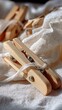 © mlangsen - Wooden clothespins on fabric