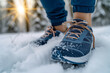 © ledor - athlete confidently laces up their high performance running shoes and fearlessly braves cold, snowy conditions during their intense winter training session