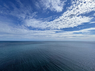 Wall Mural - endless ocean and blue sky clouds.