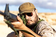 © ADDICTIVE STOCK - Soldier Wearing Uniform Aiming a Rifle in Desert Landscape