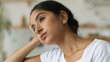 © Yuliia - Arabian woman at home Indian female girl feeling headache pain anxiety bad mental health problem trouble depression fatigue chronic migraine tired lady in living room stress debt loan bankruptcy think