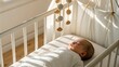© Platon - Adorable newborn resting comfortably in a safe baby bed under a charming wooden mobile, ideal for themes of childhood and family.