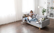 © Prostock-studio - Gadget addiction, modern technologies and millennials lifestyle. Beautiful mixed race spouses resting on sofa at home, using digital tablet and smartphone, high angle view, copy space