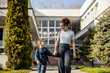© Dusan Petkovic - Young nanny is holding hands with kindergartener and taking him home from kindergarten.