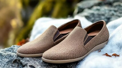 Poster - A pair of shoes resting on a rock, great for use in travel or outdoor settings