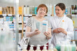 © JackF - Elderly woman buyer choosing moisturizing cream with help of young woman pharmacist in pharmacy