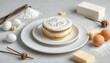 © avissarahmanita - Delicious Layered Cake Adorned with Baking Ingredients and Elegant Frosting on White Plate Sweet Concept