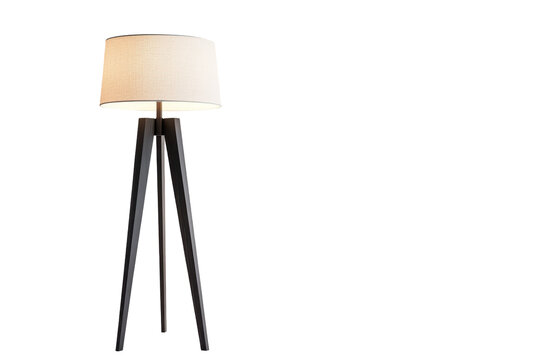Three-legged floor lamp with a white shade, set against a neutral gray wall, creating a sense of modern design.