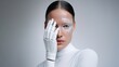 © dinatychynska - Female model with robotic prosthetic hand and pearlescent sea-inspired makeup, futuristic beauty concept, minimal background, cyber fashion, elegance meets advanced technology.