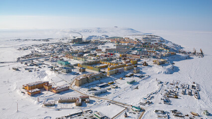 Wall Mural - The city of Anadyr, Chukotka, Russia. General view from above of the city of Anadyr, located among the snow-covered tundra on the coast of the frozen Anadyr estuary. Northern city in the Arctic.