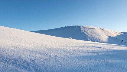 Wall Mural - serene snowy hill under clear blue sky creates peaceful winter landscape. gentle slopes of hill are covered in fresh snow, inviting tranquility and reflection