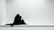 © vattana - Mysterious Figures Enveloped in Black Fabric Seated on a Minimalist White Platform in a Sterile White Room