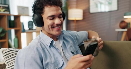 Aufkleber - Headphones, phone and man with coffee on sofa in home for chatting, relaxing and listening to music. Audio tech, cellphone and male person with networking and streaming album with tea in living room.