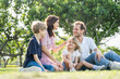 Happy family parent children having picnic outdoor activity. Enjoy happiness moment summer playing together including father mother son and daughter relaxing in the morning sunrise.