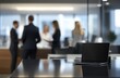 © Safat's Hub - Business people standing in a conference room with a laptop on the table
