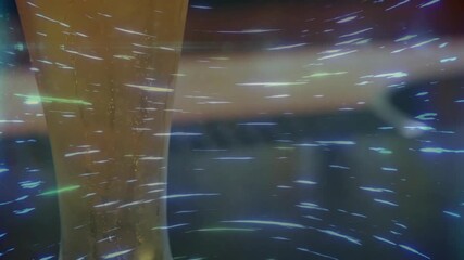 Poster - Abstract scene showing glowing light streaks moving across translucent amber column in 3D render