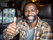 © Thanakorn - Smiling man giving thumbs up while sitting in van, expressing positivity and confidence. His casual attire and friendly demeanor create welcoming atmosphere
