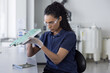 © ReeldealHD images - Woman Inspecting Electronic Circuit Board