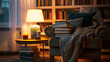 © Strother - Cozy evening scene in a home library featuring a comfortable armchair with books and blanket, illuminated by a warm lamp and candle. Relaxing ambiance.